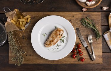Grilled chicken breast and vegetables on the plate