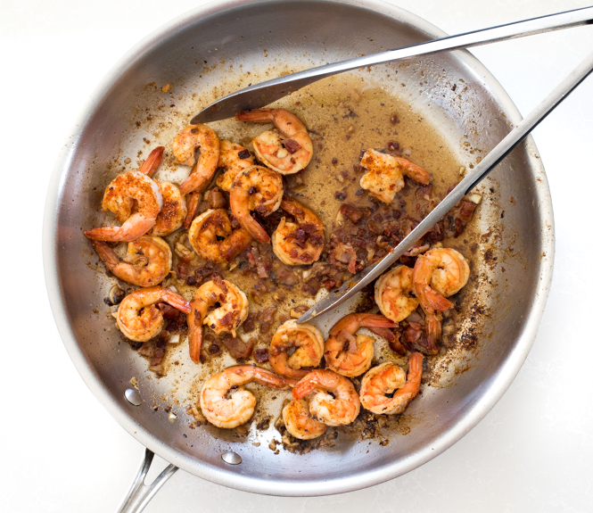 Creamy Shrimp and Grits 20 tossing shrimp and bacon together in pan