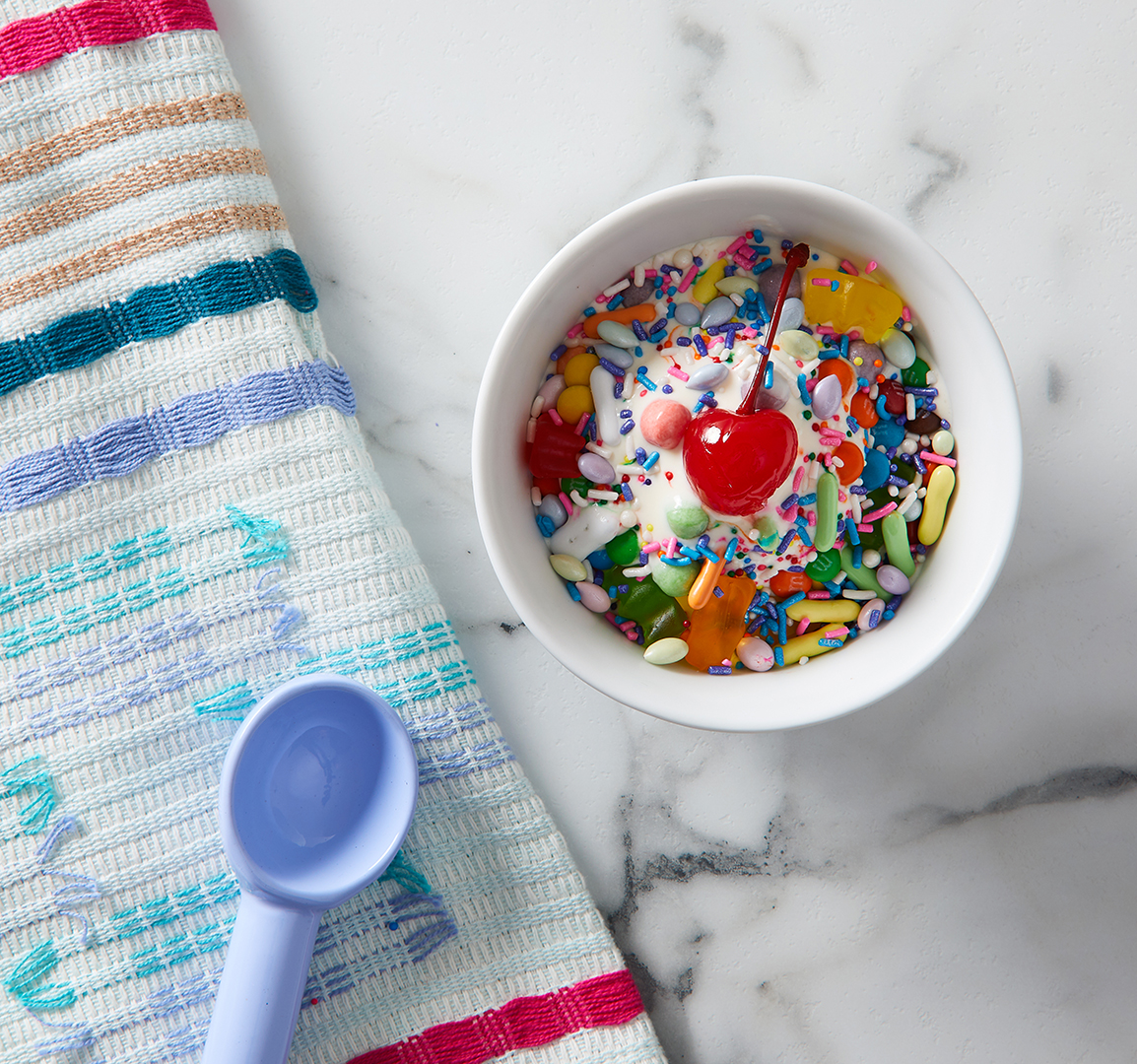 cherry and sprinkles on chocolate ice cream scoop