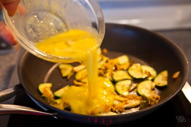 pouring egg mixture in pan