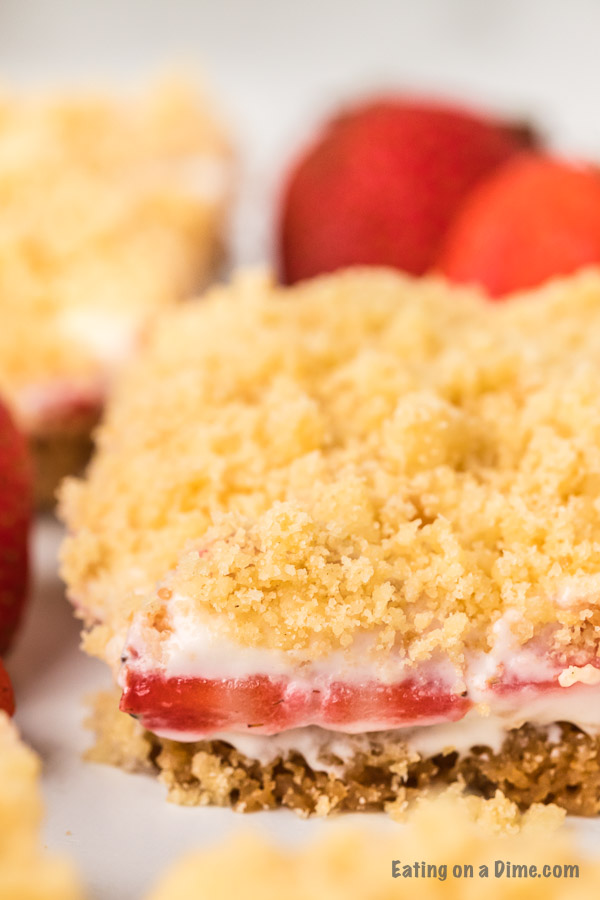 These strawberry crunch bars are easy to make and very delicious! This no bake strawberry crunch bars recipe with cookies is perfect for any occasion. These strawberry cookie bars are simple to make. You are going to love these strawberry crumb bars! #eatingonadime #easydesserts #strawberrydesserts These strawberry crunch bars are easy to make and very delicious! This no bake strawberry crunch bars recipe with cookies is perfect for any occasion. These strawberry cookie bars are simple to make. You are going to love these strawberry crumb bars! #eatingonadime #easydesserts #strawberrydesserts