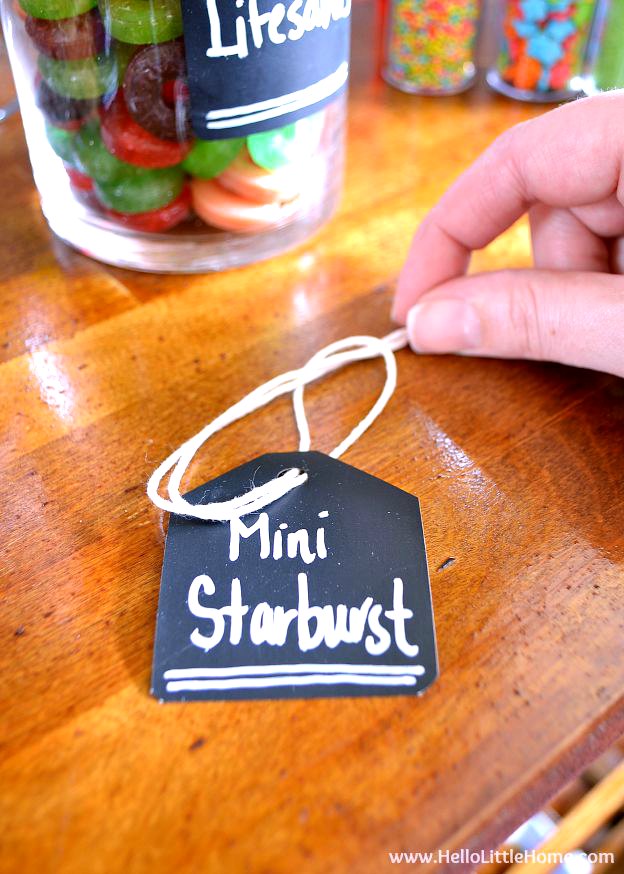 A hand adding a string to a label.