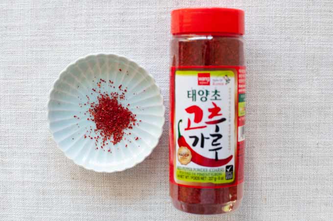Simple Kimchi Recipe 14 Korean brand corse chilli powder in a plastic bottle.