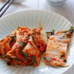 Kimchi served on a plate as a side.