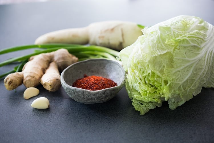 How to make Kimchi that only takes 30 minutes of hands-on-time before mother nature takes over! Full of healthy, gut-healing probiotics, this authentic kimchi recipe is vegan adaptable & gluten free. Quick and easy, make it as spicy or mild as you like. #kimchi #howtomakekimchi #vegan #vegankimchi #eatclean #cleaneating #plantbased #napa cabbage #kimchirecipe #probiotics #fermented #guthealing #fermentedcabbage #koreanfood #koreanrecipe 