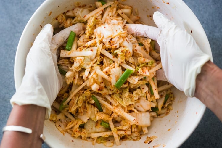 How to make Kimchi that only takes 30 minutes of hands-on-time before mother nature takes over! Full of healthy, gut-healing probiotics, this authentic kimchi recipe is vegan adaptable & gluten free. Quick and easy, make it as spicy or mild as you like. #kimchi #howtomakekimchi #vegan #vegankimchi #eatclean #cleaneating #plantbased #napa cabbage #kimchirecipe #probiotics #fermented #guthealing #fermentedcabbage #koreanfood #koreanrecipe 