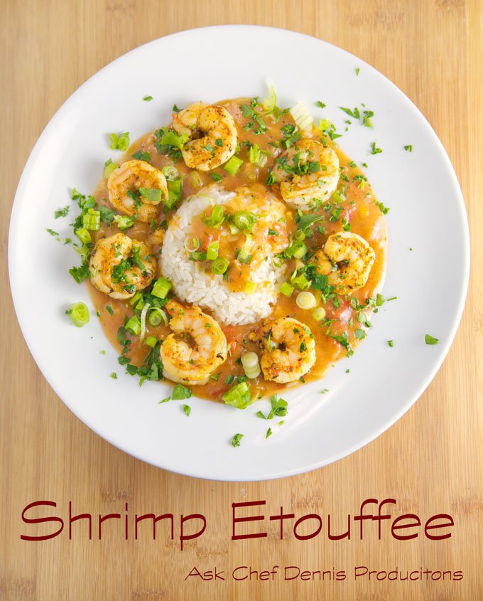 shrimp etouffee with white rice on a white plate sitting on a cutting board