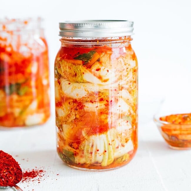 Homemade kimchi in a mason jar with white background