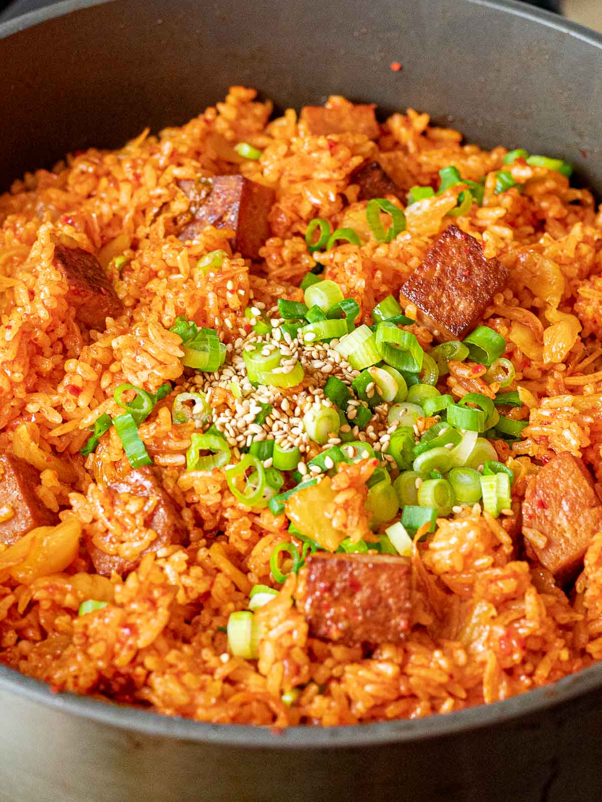 Kimchi Fried Rice with Spam 34 kimchi fried rice with spam with green onions and sesame seeds in a pan