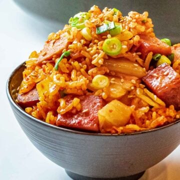 Kimchi Fried Rice with Spam 40 bowl of kimchi fried rice with spam topped with scallions and sesame seeds