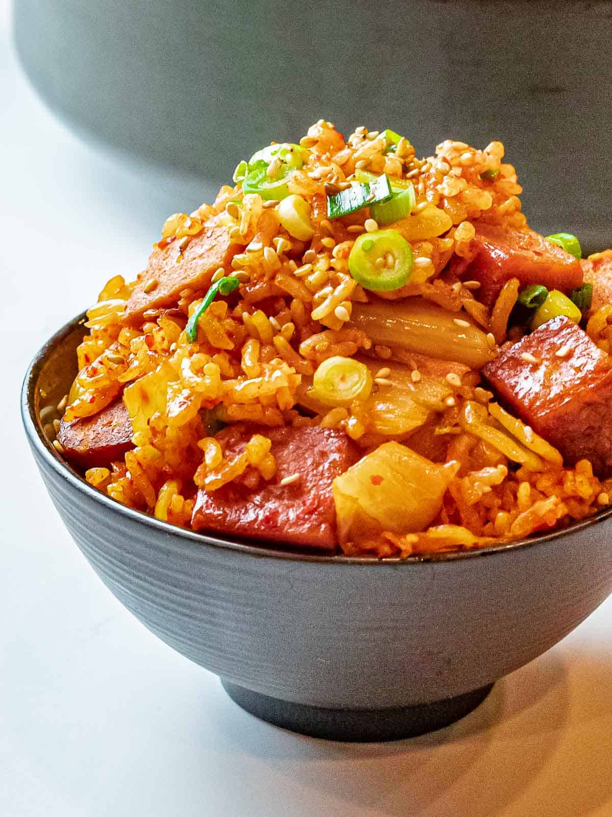 Kimchi Fried Rice with Spam 22 bowl of kimchi fried rice with spam topped with scallions and sesame seeds