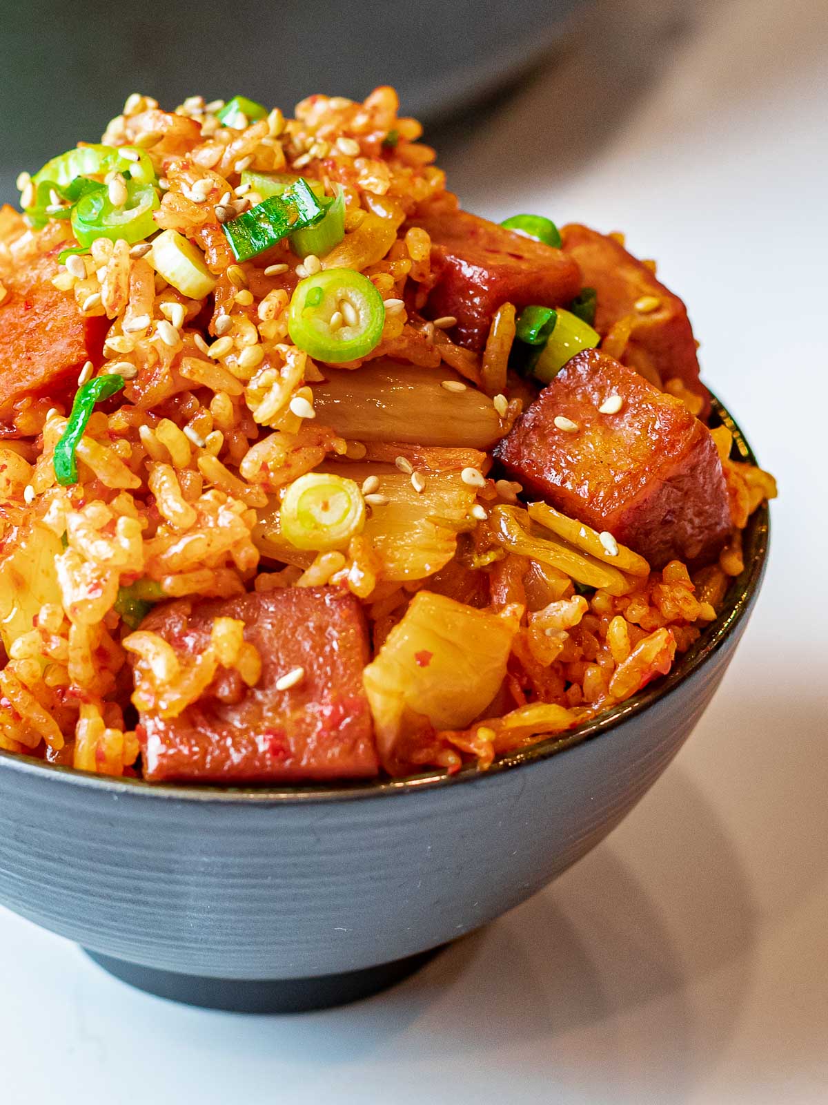 Kimchi Fried Rice with Spam 36 bowl of kimchi fried rice with spam topped with scallions and sesame seeds