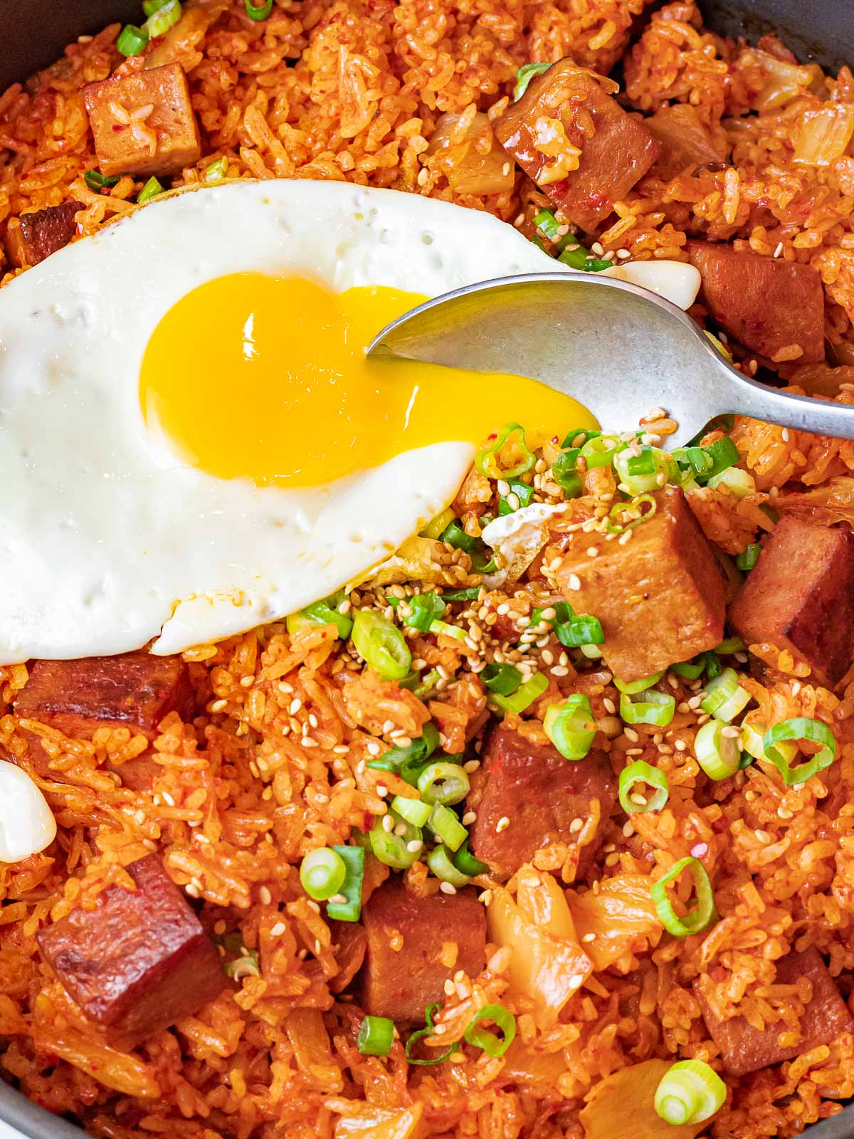 Kimchi Fried Rice with Spam 24 kimchi fried rice with spam topped with a sunny side up egg with a spoon