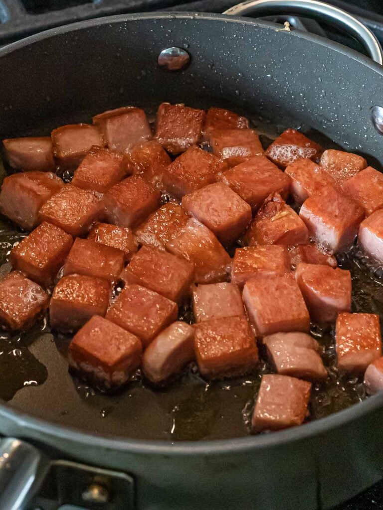 Kimchi Fried Rice with Spam 26 cubes of spam frying in a nonstick pan