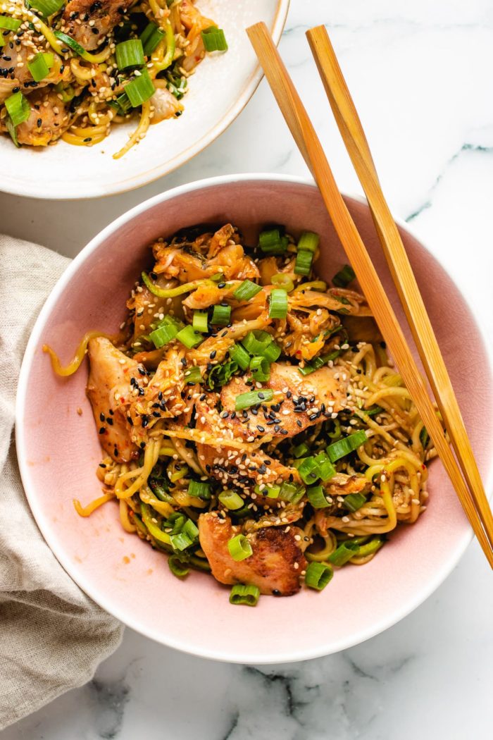 Kimchi Chicken Stir-Fry Noodle Bowl - I Heart Umami® 18 An overhead shot shows two serving bowls with kimchi chicken stir fry