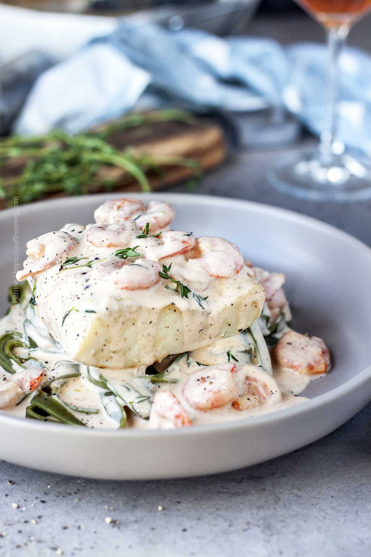 Shrimp cream sauce for fish and pasta - shown with cod fillet and spinach fettuccine..