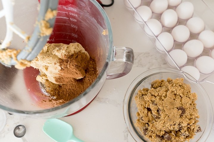 S'mores Brownie Cookie (Crumbl Copycat) - Cooking With Karli 13 cocoa powder being added to the other half of the cookie dough in the stand mixer.