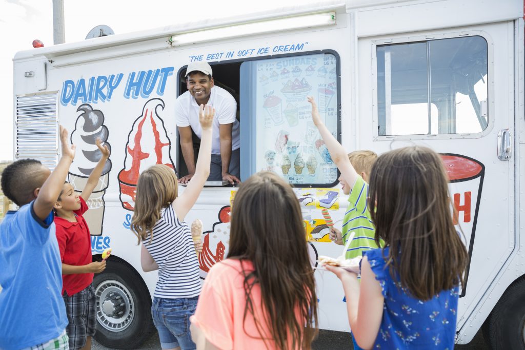 kids outside an ice cream truck, group of kids in front of an ice cream truck 