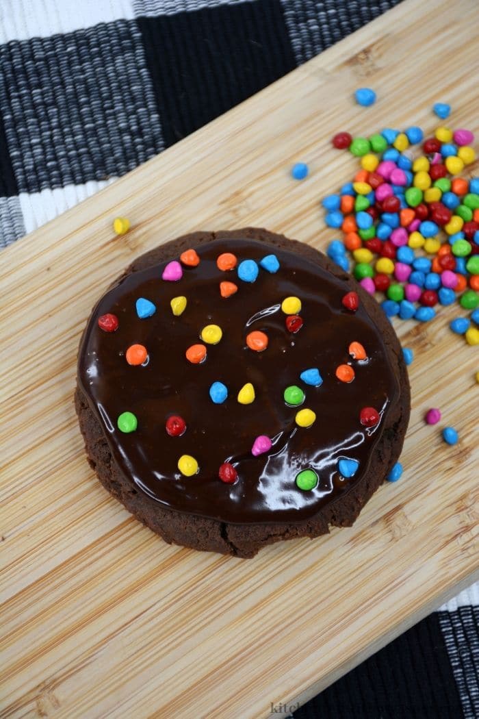 Adding the rainbow colored chocolate chip cookies.